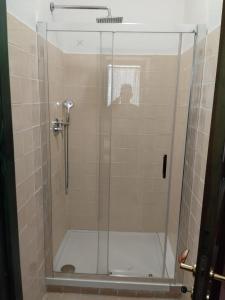 a shower stall with a glass shower door at Villaggio Sa Ventana in Badesi +17 photos