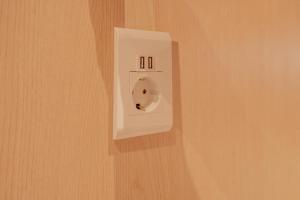 a white outlet on a wall in a room at yulstay in Seoul
