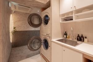 a kitchen with three washing machines and a sink at yulstay in Seoul +114 photos