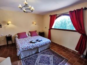 a bedroom with a bed and a large window at Domaine Mariedal in Hauterives