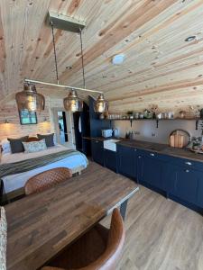 a bedroom with a bed and a wooden ceiling at New Farm Cheshire Holidays in Winsford