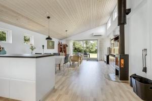 a kitchen and living room with white cabinets and a table at 30140-Malling-Askvaenget-5 in Malling +28 photos