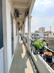 a balcony of a building with potted plants at Hàng Xanh Stay in Ho Chi Minh City