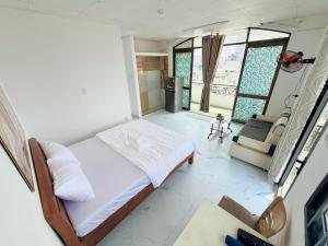 a bedroom with a bed and a living room at Hàng Xanh Stay in Ho Chi Minh City