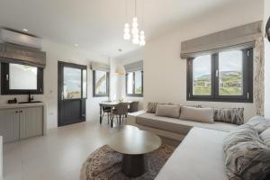 a living room with a couch and a table at Galaria Serenity Suites in Vóthon +83 photos