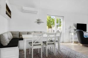 a white dining room with a white table and chairs at 1061-N-Vejby-Lundebakken-1 in Vejby +14 photos