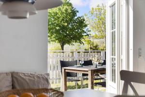 a room with a table and chairs on a patio at 1061-N-Vejby-Lundebakken-1 in Vejby