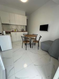 a living room with a table and chairs and a couch at Sunset Apartment B-3 in Perea