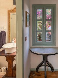 a bathroom with a sink and a window at LAGO Skiathos Guest Suites in Skiathos