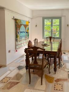 a dining room with a wooden table and chairs at LAGO Skiathos Guest Suites in Skiathos +54 photos