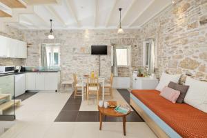 a living room with a couch and a table at Corfu Breeze Liston Apartments in Corfu