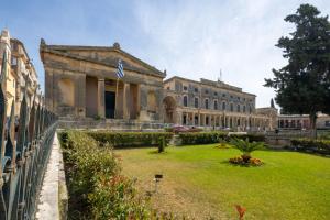 a large building with a lawn in front of it at Corfu Breeze Liston Apartments in Corfu