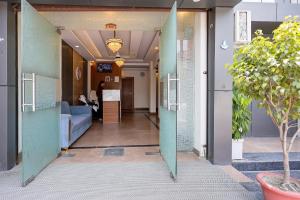 a hallway of a building with a couch and a table at Fabhotel Imperial 900 m from Sarnath Museum in Varanasi