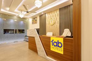 a hotel reception desk with aida hotels sign in a lobby at Fabhotel Imperial 900 m from Sarnath Museum in Varanasi