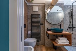 a bathroom with a sink and a mirror at Alpine Lodge Green by Tss - Downtown, classy in Levico Terme +14 photos