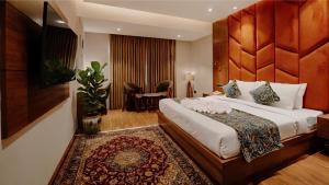 a hotel room with a large bed in a room at The Olive Hotel Srinagar in Srinagar +47 photos