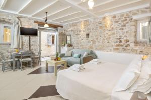 a living room with a stone wall at Corfu Breeze Liston Apartments in Corfu