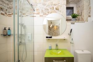 a bathroom with a green sink and a shower at Corfu Breeze Liston Apartments in Corfu +17 photos