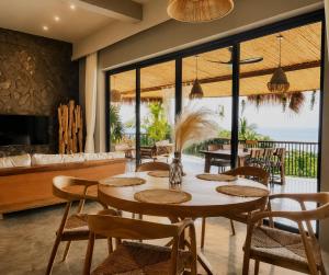 a dining room with a table and chairs at SANA Koh Phangan in Salad Beach