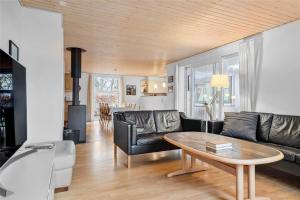 a living room with a couch and a table at 30640-Odder-Magevej-7 in Odder