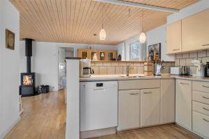 a kitchen with a white refrigerator and a stove at 30640-Odder-Magevej-7 in Odder