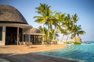 a resort with a pool and chairs and palm trees at Ananea Madivaru Maldives in Toroka