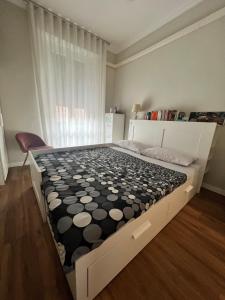 a bed with a black and white pattern on it at 5 min from the center, Elevator , 4 guests, 2 bedrooms in Turin