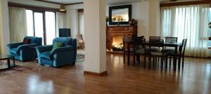 a living room with a dining room table and chairs at Anandam in Mashobra
