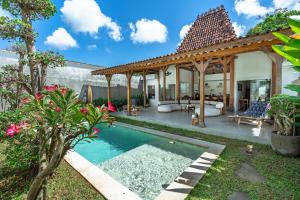a backyard with a swimming pool and a pavilion at Bingin Villas Luxury, Concierge and Security in Uluwatu
