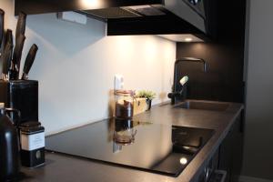 a kitchen with a counter top with a sink and a counter top at Moderne toppleilighet i Bergen in Bergen +14 photos