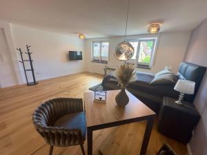 a living room with a couch and a table at TIME OUT Apartments in Balingen