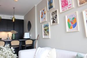 a living room with a white couch and pictures on the wall at Moderne toppleilighet i Bergen in Bergen
