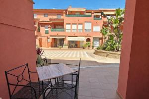 a patio with a table and chairs in front of a building at Rinconcito Roteńo in Rota