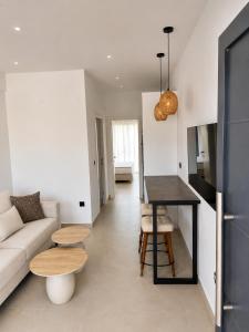 a living room with a couch and a table at Salsedo Seaside Rooms in Kanali