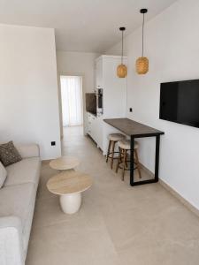 a living room with a couch and a table at Salsedo Seaside Rooms in Kanali
