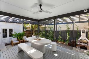 a patio with a white table and a grill at La Mer in Marcoola in Marcoola