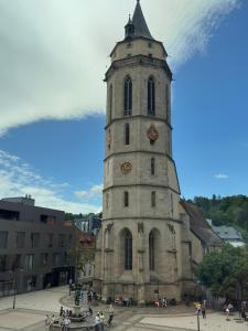 a tall tower with a clock on a building at TIME OUT Apartments in Balingen