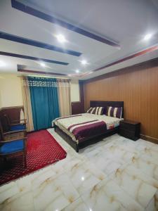 a bedroom with a bed and a red carpet at Stylish Apartment in Khaira Gali