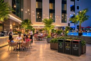 people sitting at tables in a restaurant in a building at Khalidia Palace Hotel Dubai in Dubai