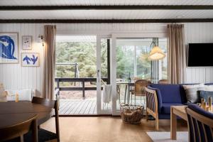 a living room with a blue couch and a table at 1115-Ringkobing-Nordsovej-466 in Søndervig