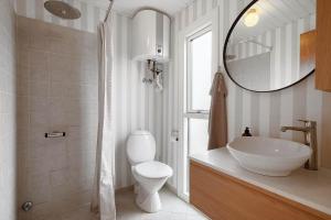 a bathroom with a sink and a toilet and a mirror at 1115-Ringkobing-Nordsovej-466 in Søndervig +53 photos