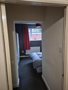 a small room with a bed and a window at Beach Next Door Flat Retreat and Free Parking in Margate