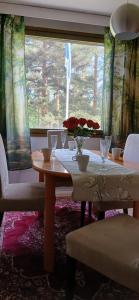 a table with a vase of flowers on it at Saimaa Parkview Luxury Suite in Savonlinna +22 photos