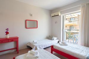 a room with two beds and a window at Hotel Asimina Laganas in Laganas