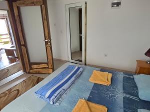 a room with a bed and a mirror at Sinemoria apartment in Sinemorets