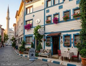 a building on a street with tables and chairs at elisa hotel in Istanbul