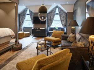 a hotel room with a bed and a living room at Hotel Union Geiranger Resort & Spa in Geiranger
