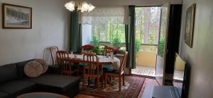 a dining room with a table and chairs and a window at Saimaa Parkview Luxury Suite in Savonlinna