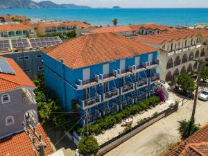 an aerial view of a blue building with orange roofs at Hotel Asimina Laganas in Laganas +32 photos