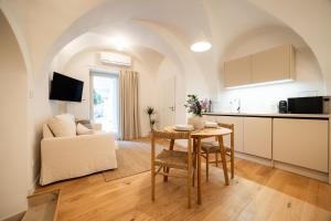 a kitchen and living room with a table and a couch at Vila Dolná in Banská Bystrica